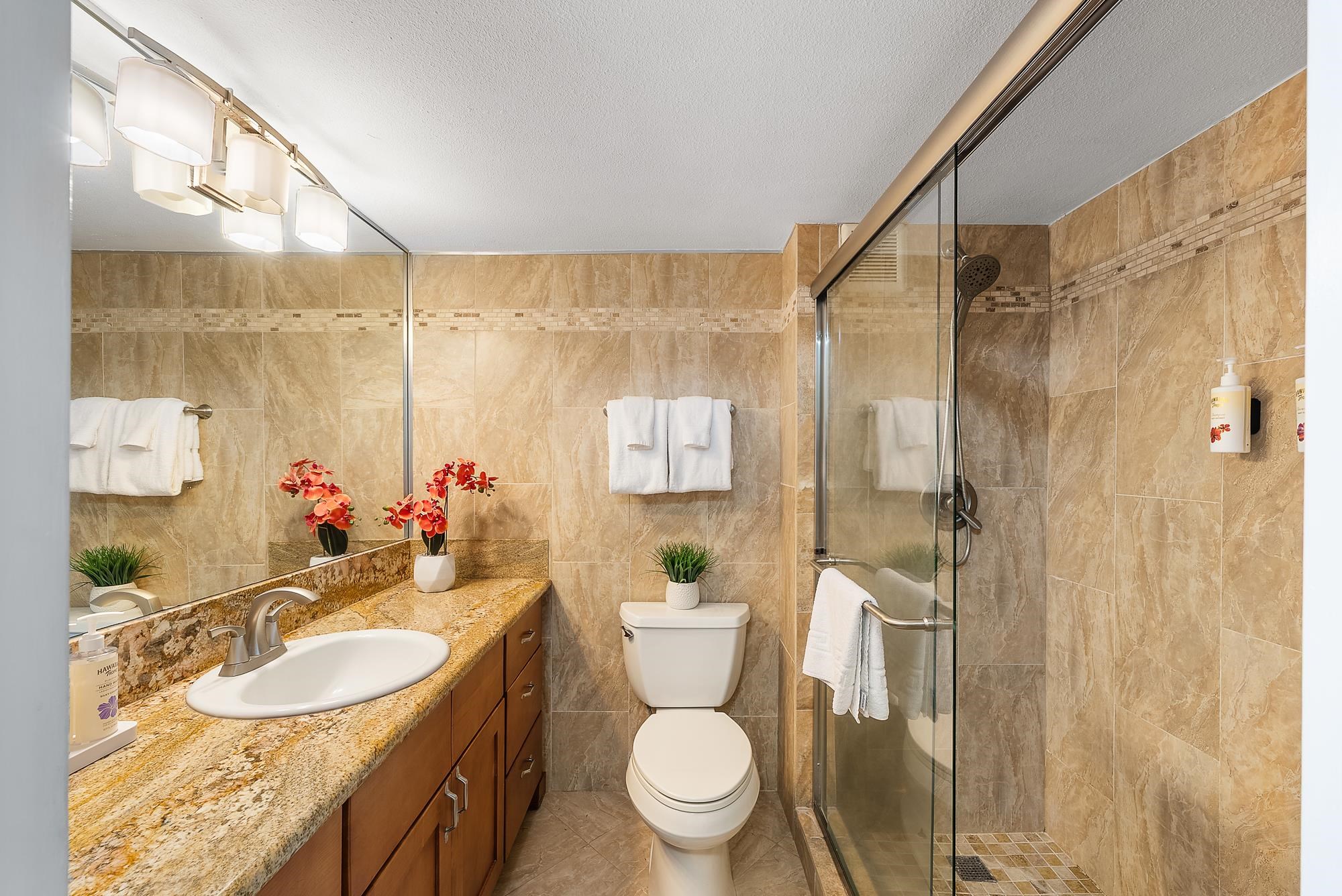 4471 Lower Honoapiilani Road, Unit 118 Lahaina, HI 96761 - Photo 16 of 41 a bathroom with a sink toilet a mirror and shower