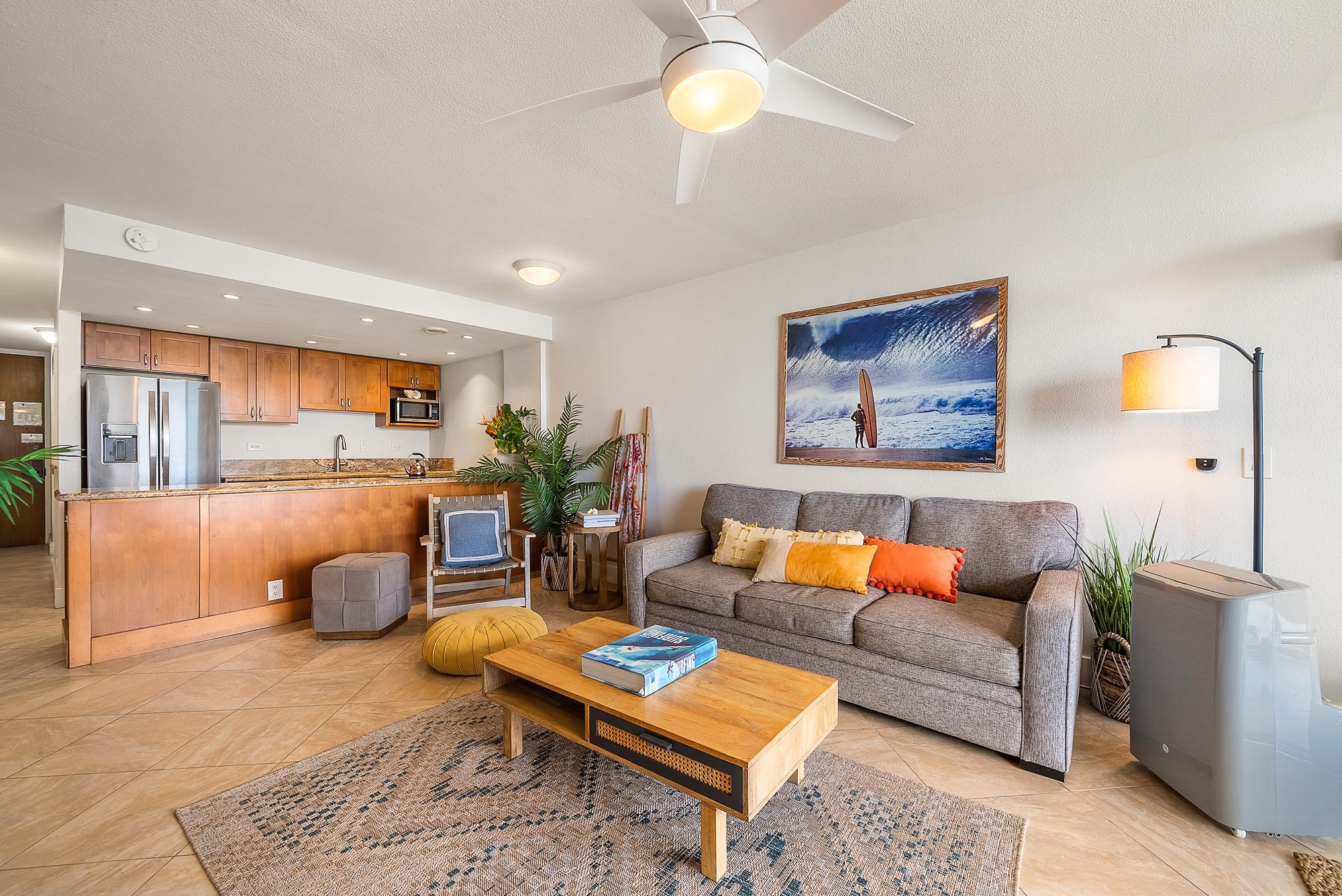 4471 Lower Honoapiilani Road, Unit 118 Lahaina, HI 96761 - Photo 19 of 41 a living room with furniture a rug and a chandelier