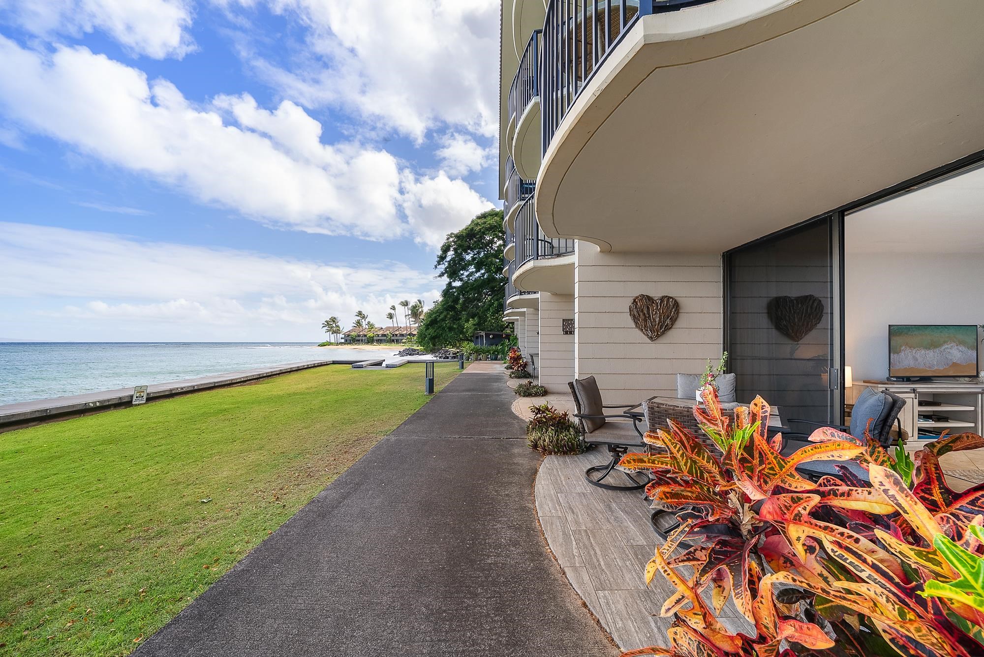 4471 Lower Honoapiilani Road, Unit 118 Lahaina, HI 96761 - Photo 21 of 41 a view of a swimming pool with a garden and seating area