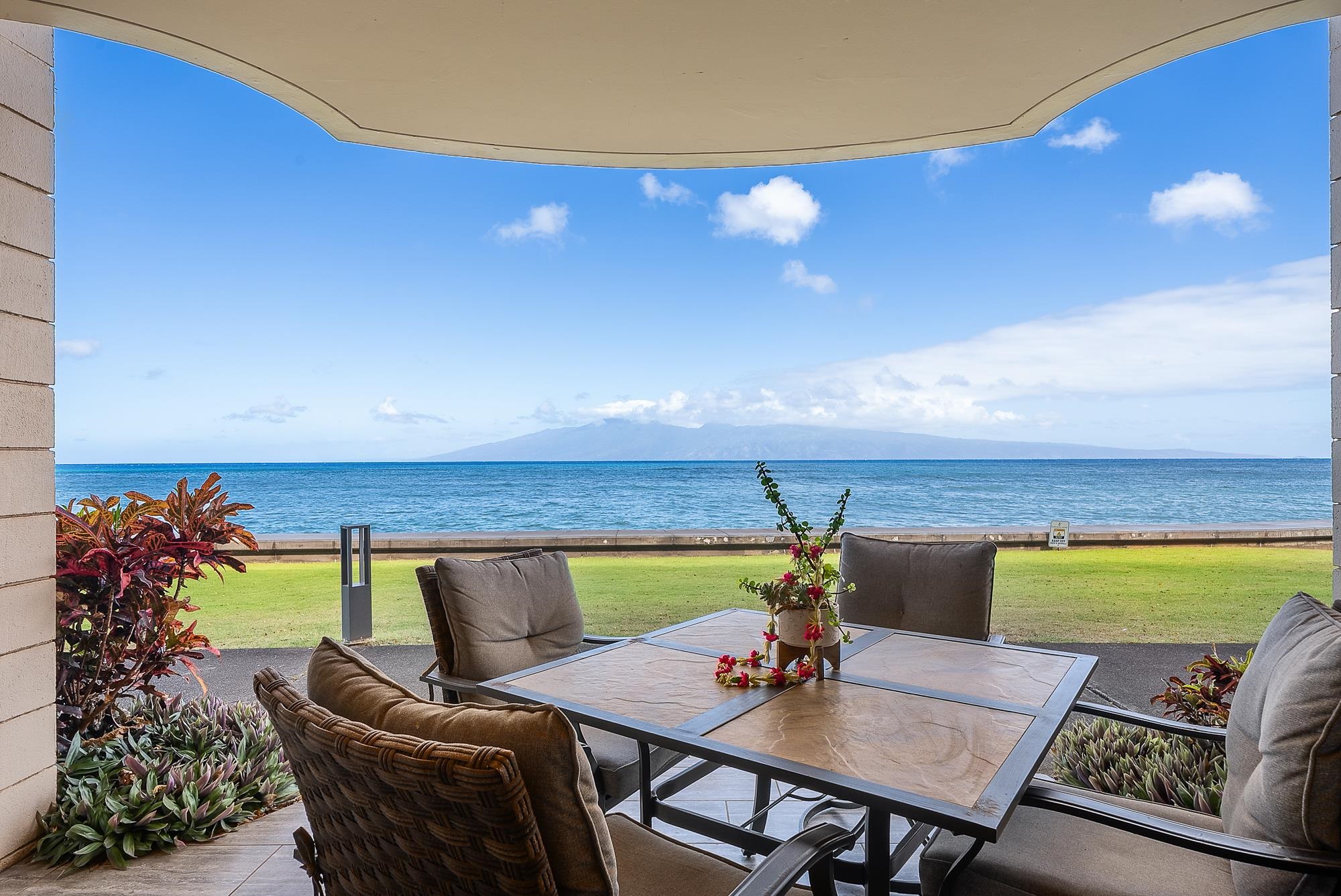 4471 Lower Honoapiilani Road, Unit 118 Lahaina, HI 96761 - Photo 25 of 41 a view of a dining room with furniture and wooden floor