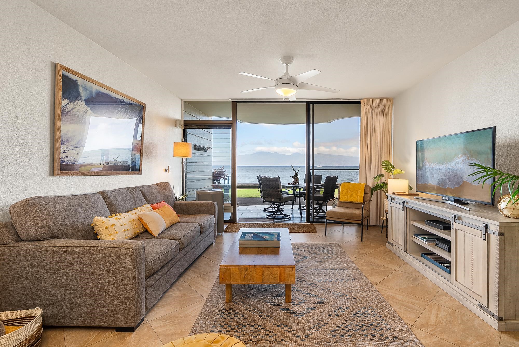 4471 Lower Honoapiilani Road, Unit 118 Lahaina, HI 96761 - Photo 9 of 41 a living room with furniture and a flat screen tv
