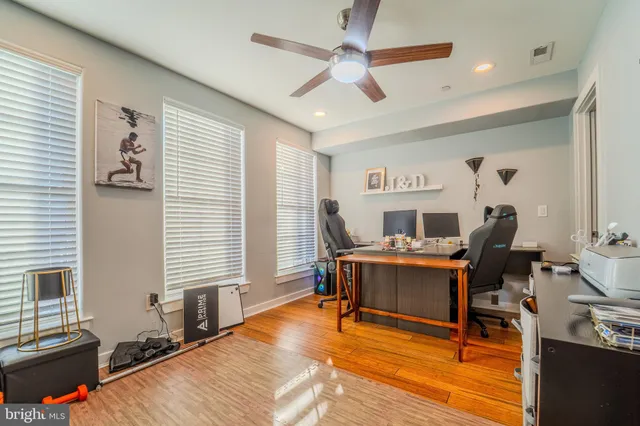 a work room with furniture and a wooden floor