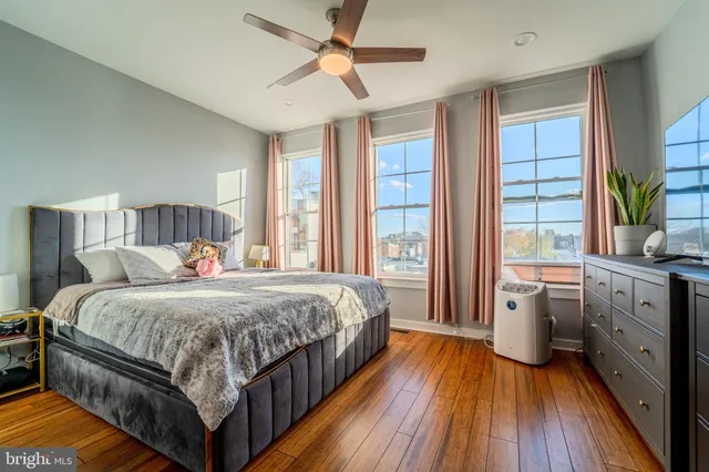 a bedroom with a large bed and a chandelier