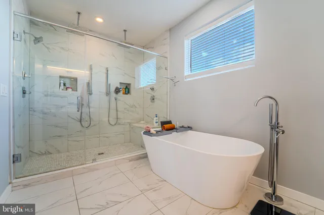 a bathroom with a sink a mirror and a shower