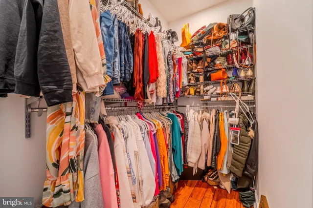 a view of walk in closet with clothes