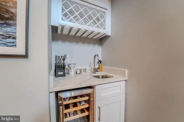 a kitchen with a sink and a mirror