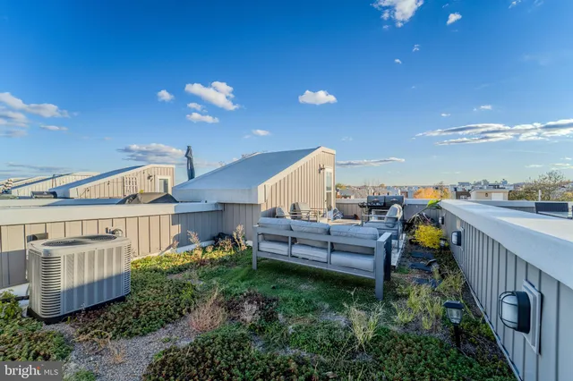 a view of a patio with table and chairs and potted plants