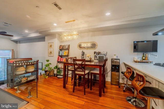 a view of a dining room with furniture and wooden floor