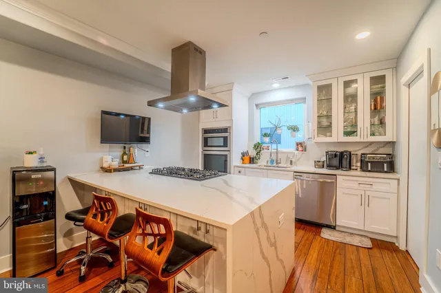 a kitchen with stainless steel appliances a sink and a refrigerator