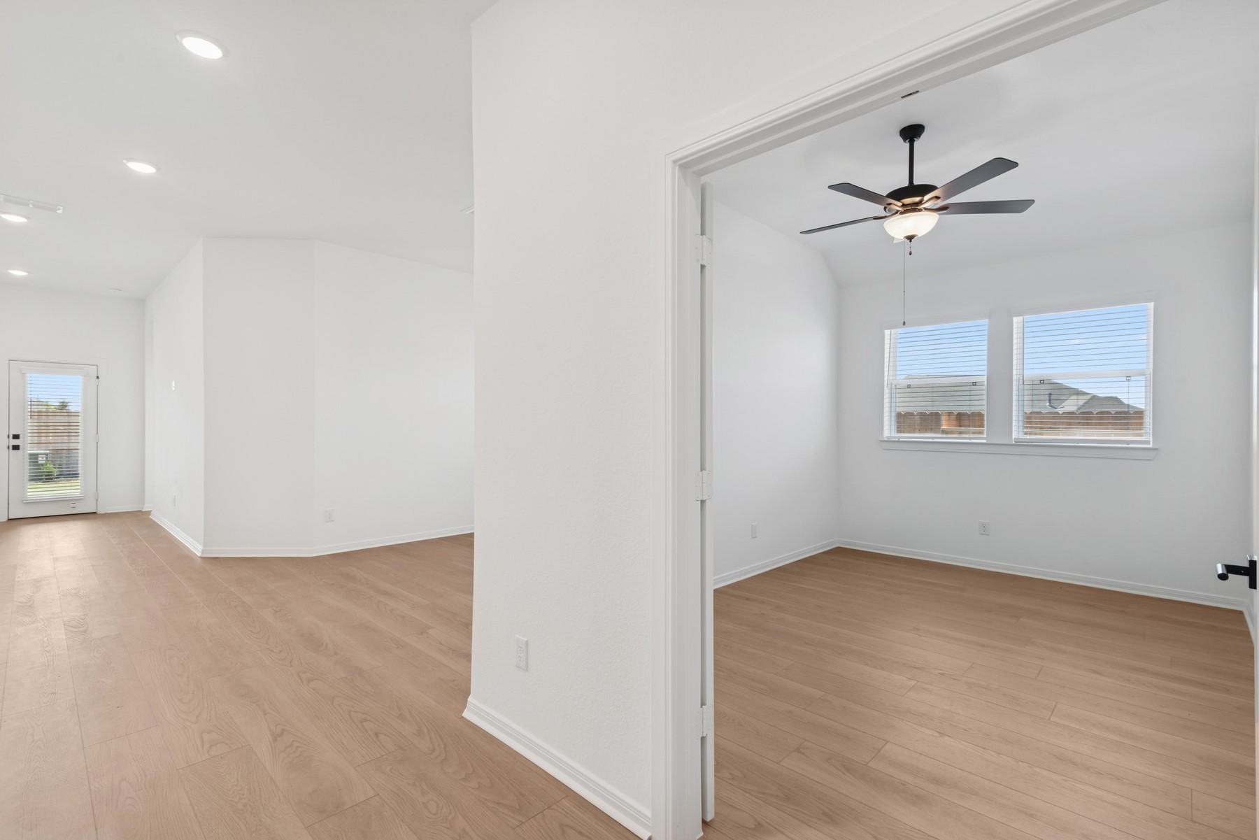 123 Blue River Trail Rosenberg, TX 77471 - Photo 22 of 46 wooden floor in an empty room with a window