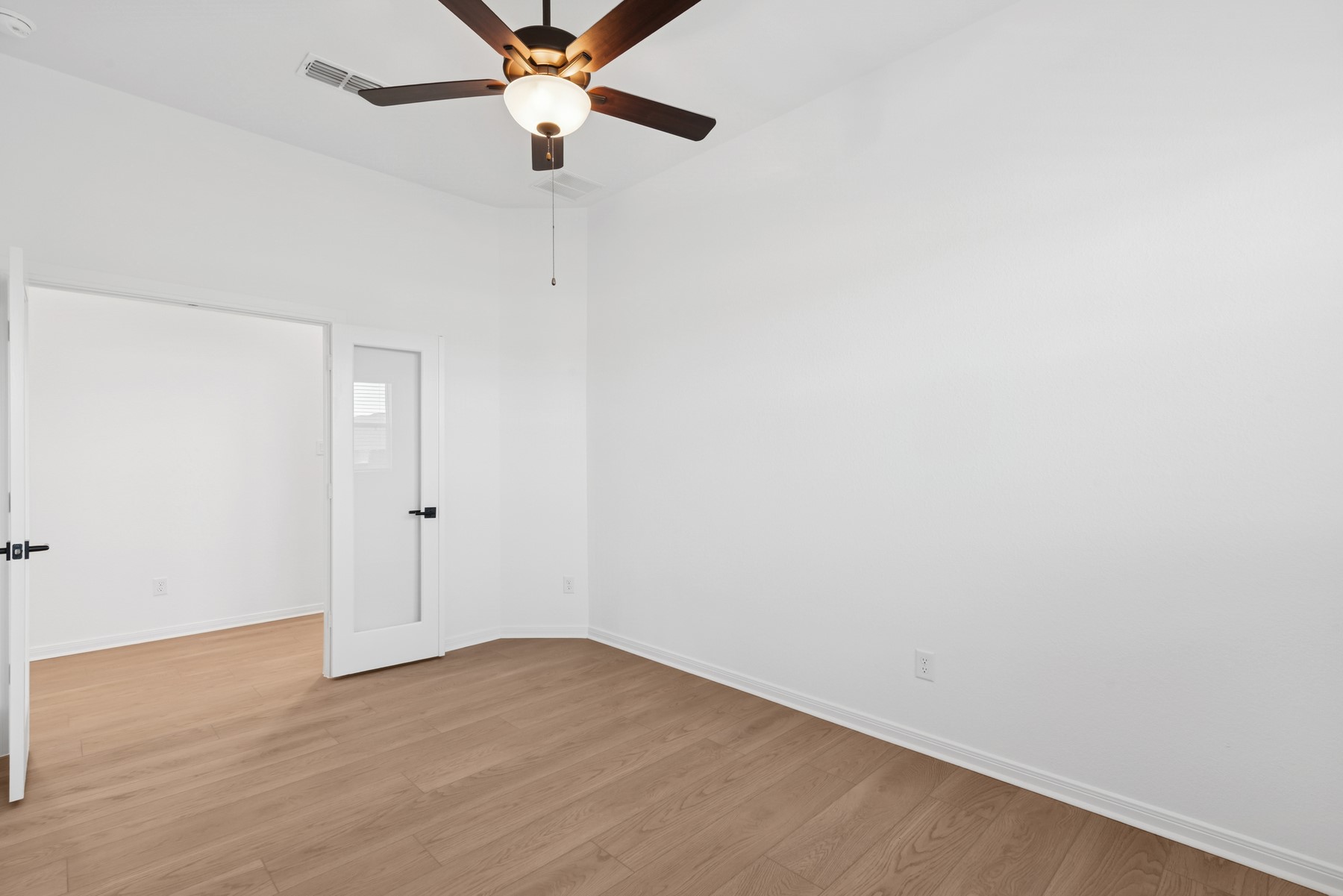 123 Blue River Trail Rosenberg, TX 77471 - Photo 23 of 46 a view of a room with a ceiling fan and wooden floor