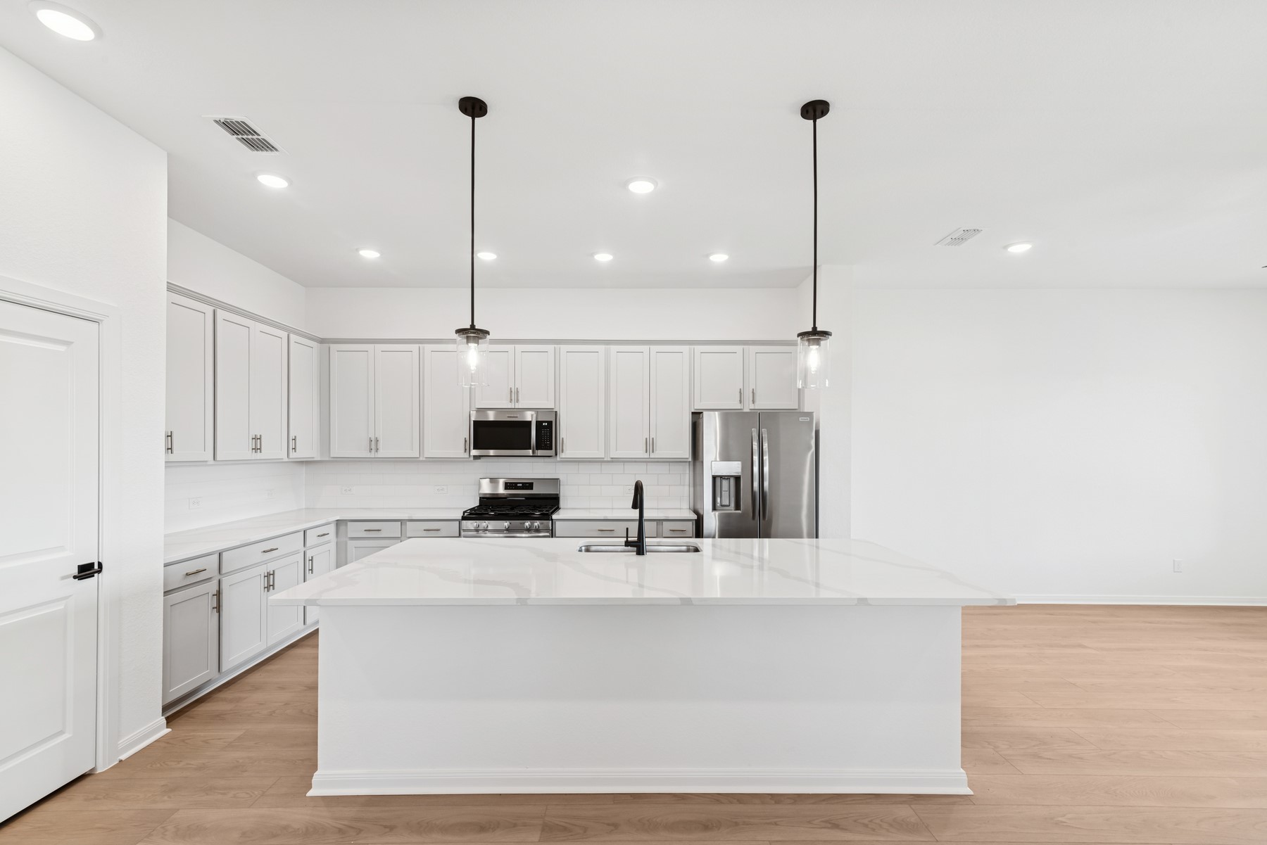 123 Blue River Trail Rosenberg, TX 77471 - Photo 25 of 46 a kitchen with kitchen island a sink stainless steel appliances and cabinets