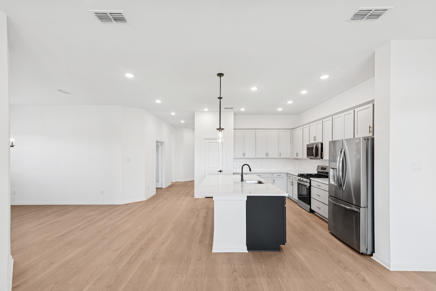123 Blue River Trail Rosenberg, TX 77471 - Photo 27 of 46 a kitchen with kitchen island a refrigerator sink and stove