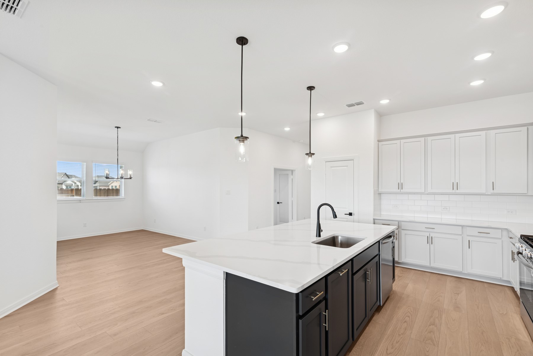 123 Blue River Trail Rosenberg, TX 77471 - Photo 29 of 46 a kitchen with kitchen island a sink a center island and stainless steel appliances