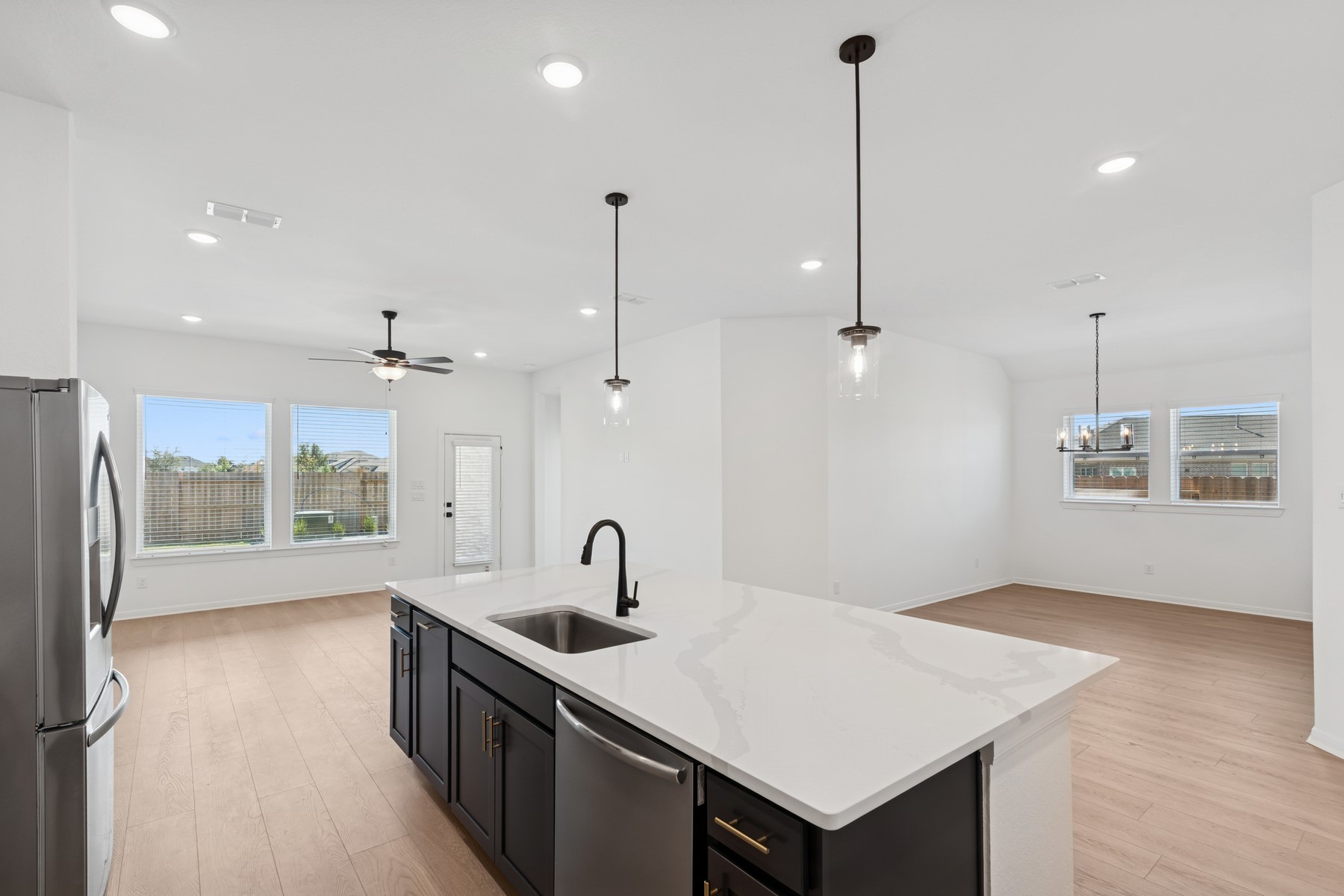 123 Blue River Trail Rosenberg, TX 77471 - Photo 30 of 46 a kitchen with a refrigerator a sink and wooden floor