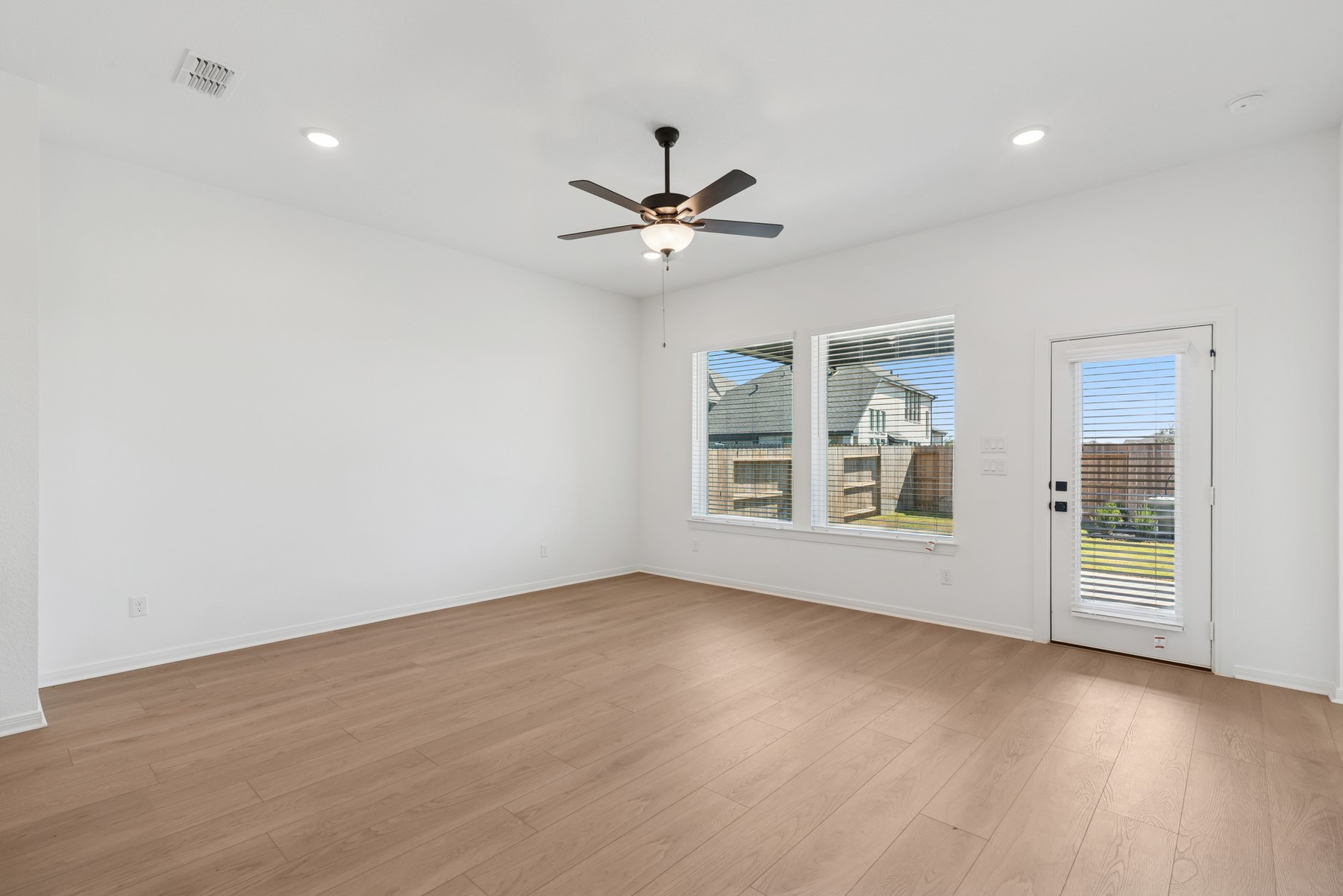 123 Blue River Trail Rosenberg, TX 77471 - Photo 34 of 46 a view of an empty room with a window and wooden floor