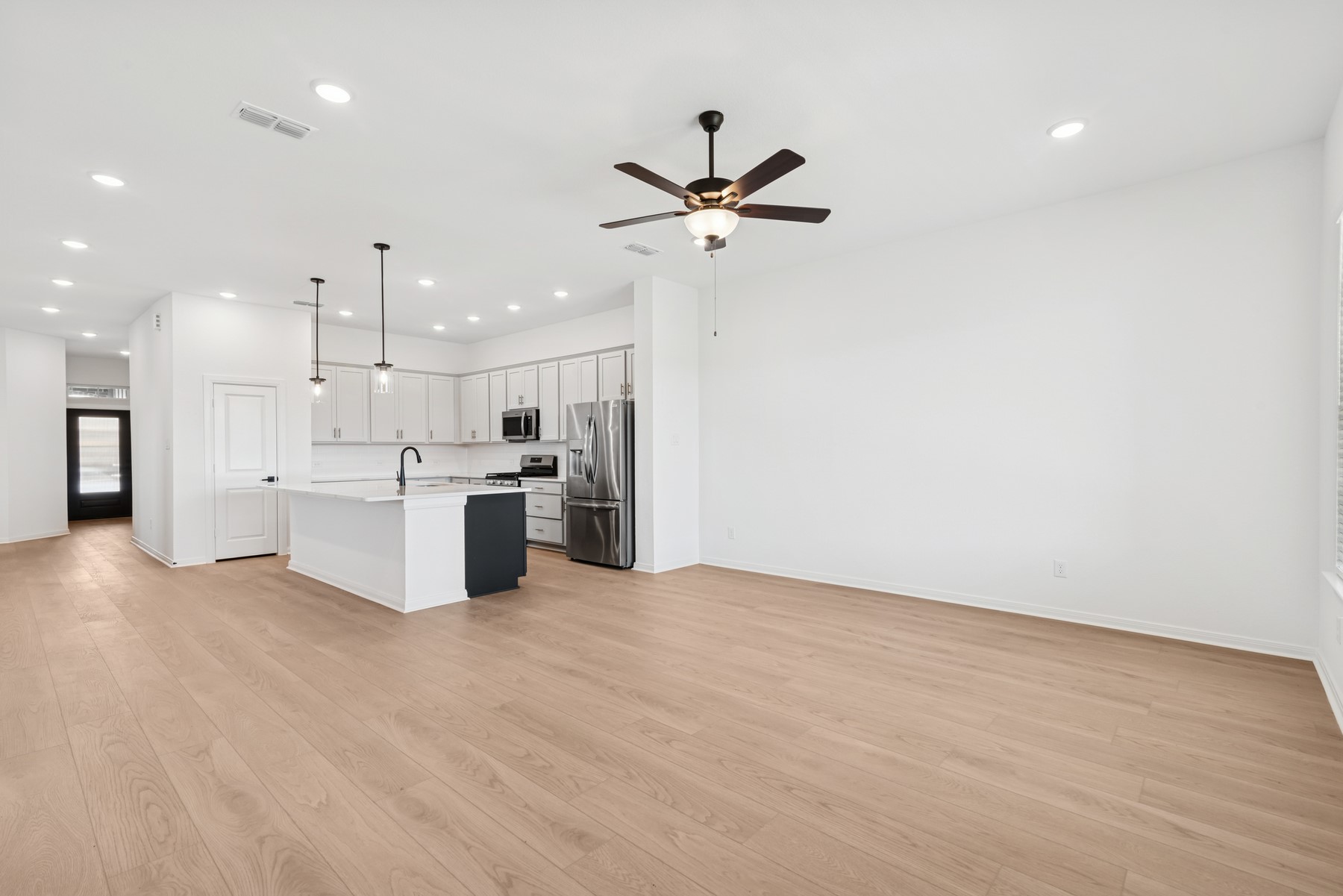123 Blue River Trail Rosenberg, TX 77471 - Photo 35 of 46 a view of kitchen with kitchen island a sink stainless steel appliances and a counter top