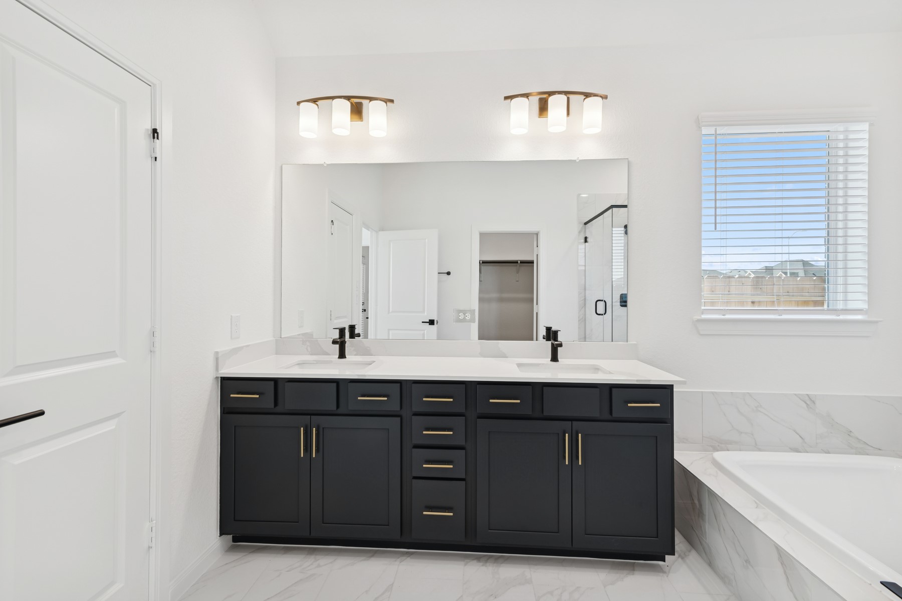 123 Blue River Trail Rosenberg, TX 77471 - Photo 41 of 46 a bathroom with a double vanity sink and mirror with bathtub