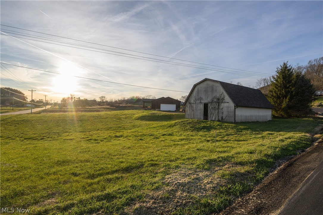 8200 Cutler Road Southwest Sherrodsville, OH 44675 - Photo 4 of 26 View of grassy yard with an outbuilding and a barn