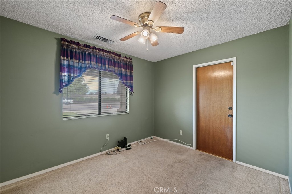 2065 Jenkins Road Bakersfield, CA 93314 - Photo 11 of 59 a view of a livingroom with a ceiling fan and window