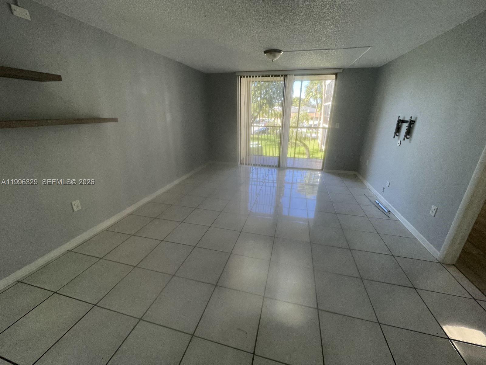 8015 Southwest 107th Avenue, Unit 221 Miami, FL 33173 - Photo 2 of 6 a view of an empty room with a window