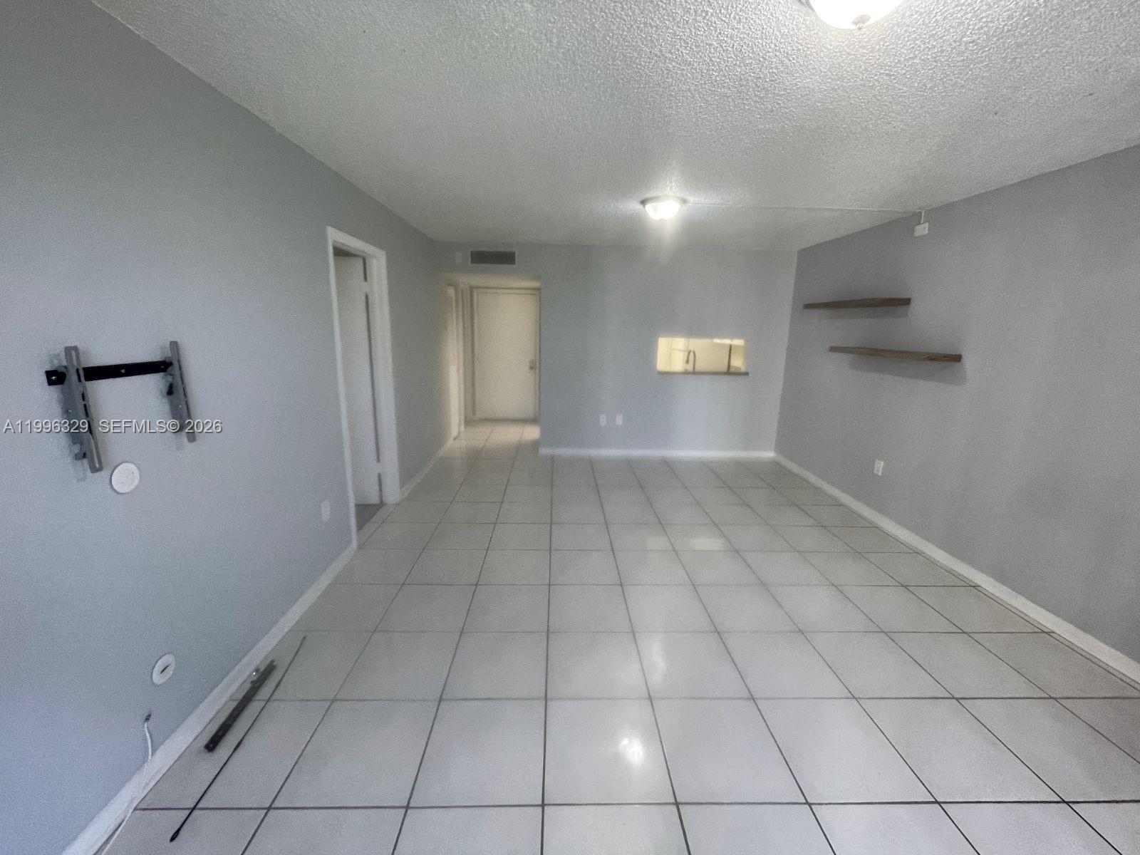 8015 Southwest 107th Avenue, Unit 221 Miami, FL 33173 - Photo 3 of 6 a view of an empty room with a window