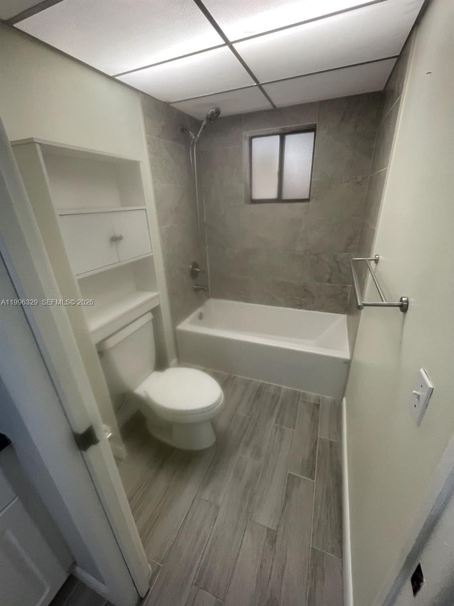 8015 Southwest 107th Avenue, Unit 221 Miami, FL 33173 - Photo 5 of 6 a bathroom with a toilet and a shower