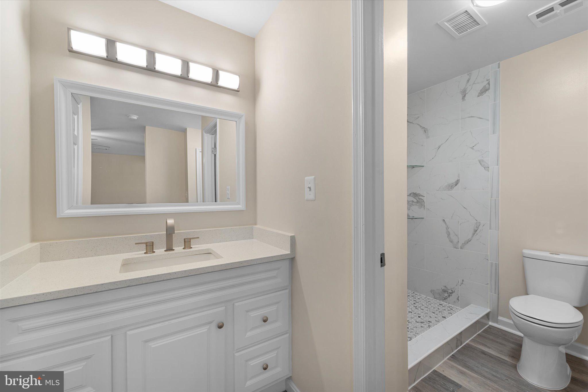 8016 Stillbrooke Road Manassas, VA 20112 - Photo 23 of 41 a bathroom with a sink a toilet and shower