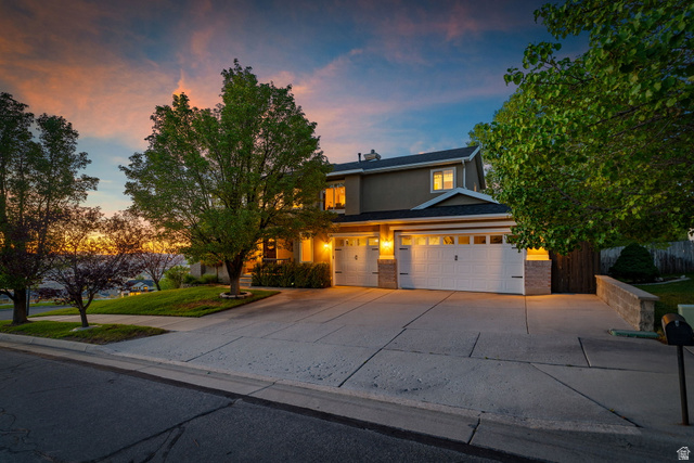 14883 Tooele Lane Draper, UT 84020 - Photo 42 of 49 Contemporary two-story residence with a multi-car driveway, two garage doors with upper window panels, and a stone facade accent
