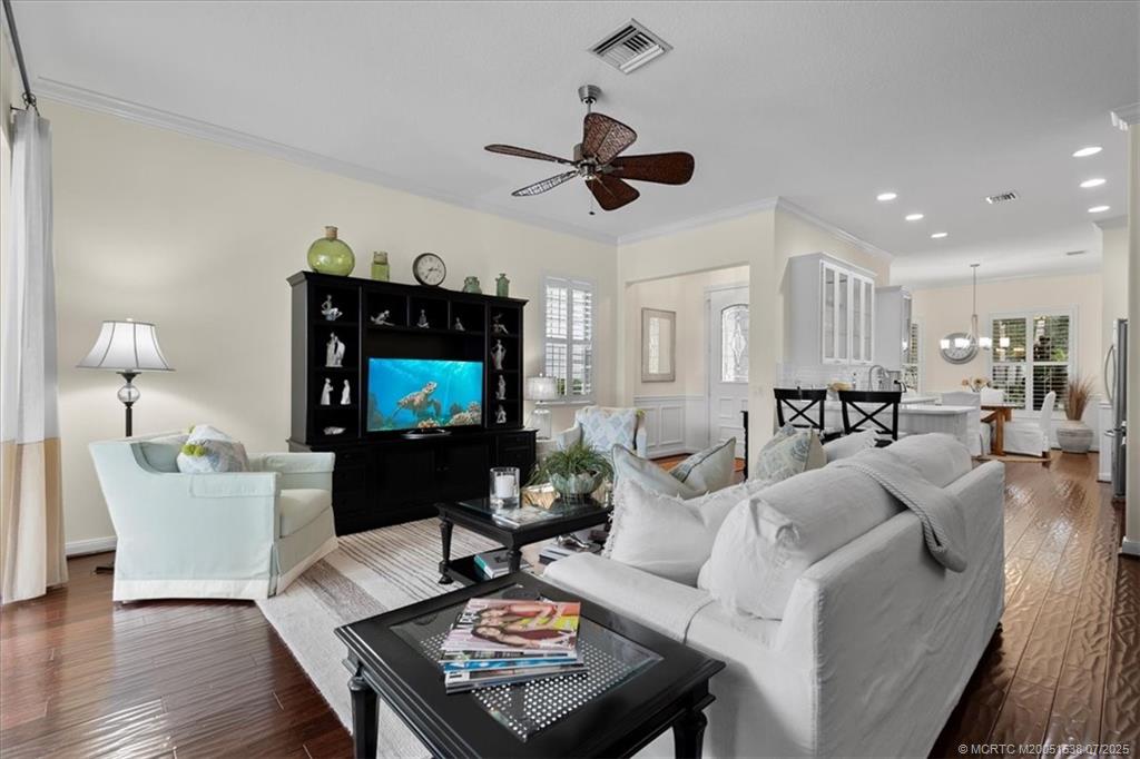 107 Castries Drive Jupiter, FL 33458 - Photo 12 of 39 a living room with furniture a rug and a flat screen tv