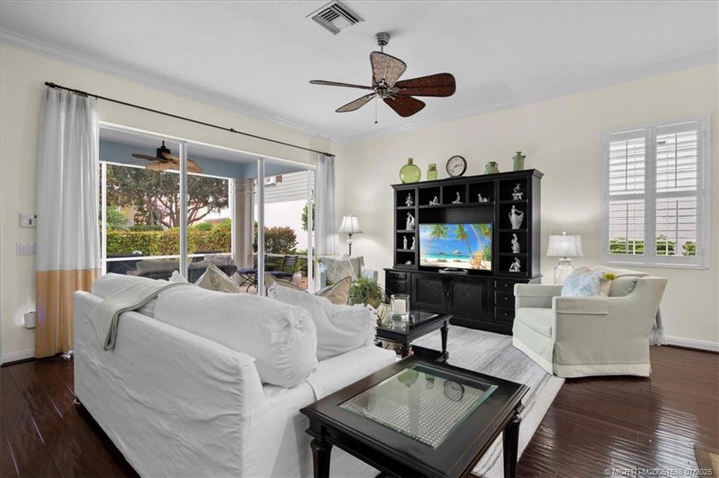 107 Castries Drive Jupiter, FL 33458 - Photo 13 of 39 a living room with furniture a flat screen tv and a large window