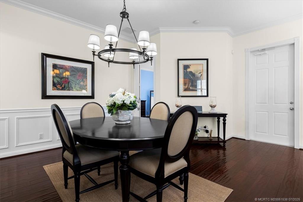 107 Castries Drive Jupiter, FL 33458 - Photo 14 of 39 a view of a dining room with furniture wooden floor and a chandelier