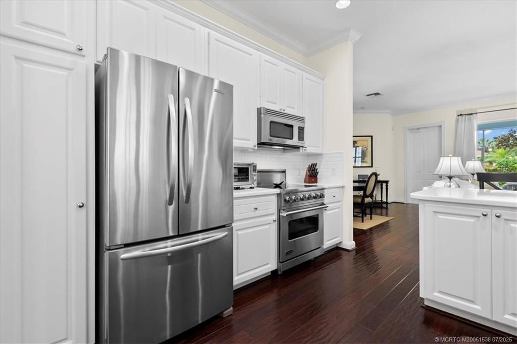 107 Castries Drive Jupiter, FL 33458 - Photo 17 of 39 a kitchen with stainless steel appliances a refrigerator stove and sink
