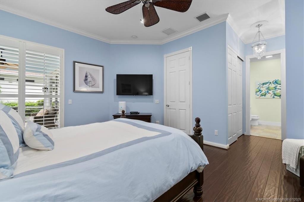 107 Castries Drive Jupiter, FL 33458 - Photo 21 of 39 a bedroom with a bed and a flat screen tv