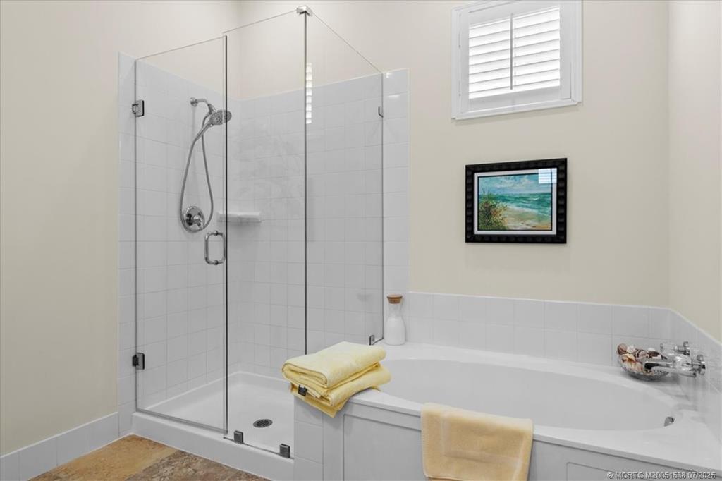 107 Castries Drive Jupiter, FL 33458 - Photo 23 of 39 a bathroom with a bathtub and a shower