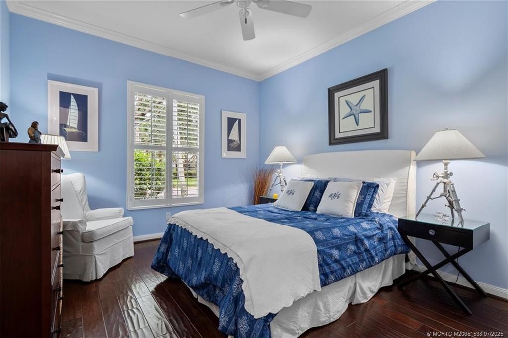 107 Castries Drive Jupiter, FL 33458 - Photo 24 of 39 a bedroom with a bed wooden floor and window