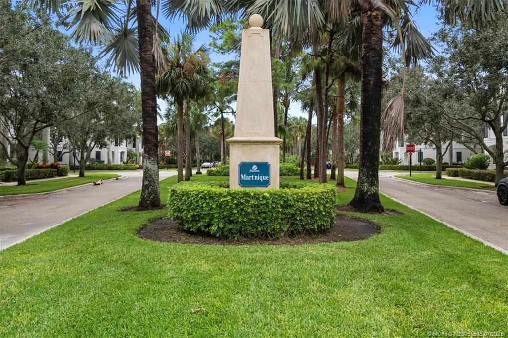 107 Castries Drive Jupiter, FL 33458 - Photo 34 of 39 a front view of a building with a garden and trees