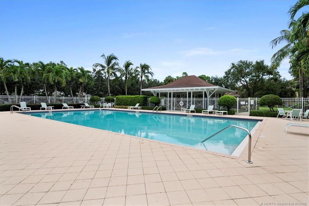 107 Castries Drive Jupiter, FL 33458 - Photo 35 of 39 a view of a swimming pool and trees in the background