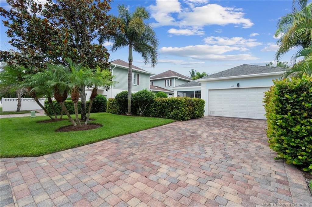 107 Castries Drive Jupiter, FL 33458 - Photo 4 of 39 a front view of a house with garden