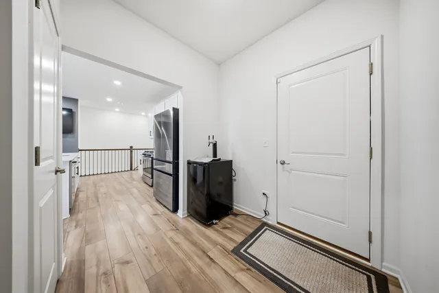 a view of a hallway with wooden floor