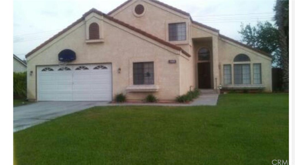 1183 West Cimarron Street Rialto, CA 92377 - Photo 1 of 1 Front of the home with beautiful green lawn all around the front and back as well as the sides
