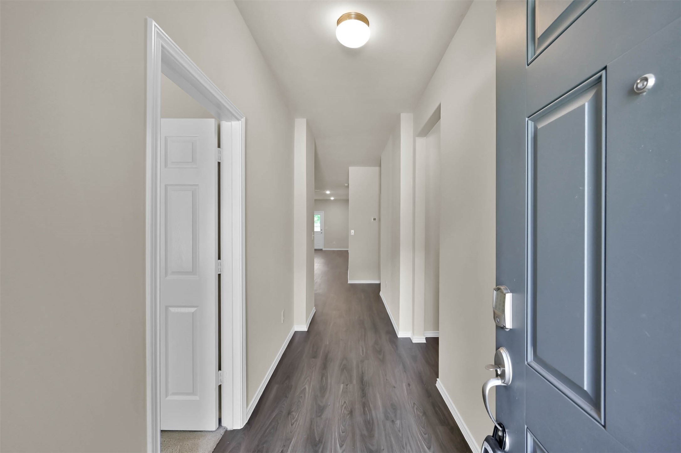 4231 Pine Still Road Conroe, TX 77304 - Photo 19 of 27 Front entry hallway! Bedroom with private bath is to the left. Laundry and garage are to the right!