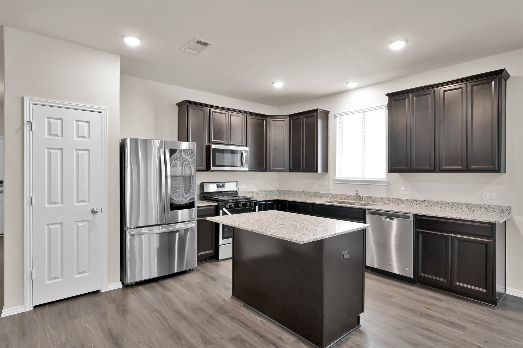 4231 Pine Still Road Conroe, TX 77304 - Photo 3 of 27 Open concept kitchen with gas stove! Fridge included!