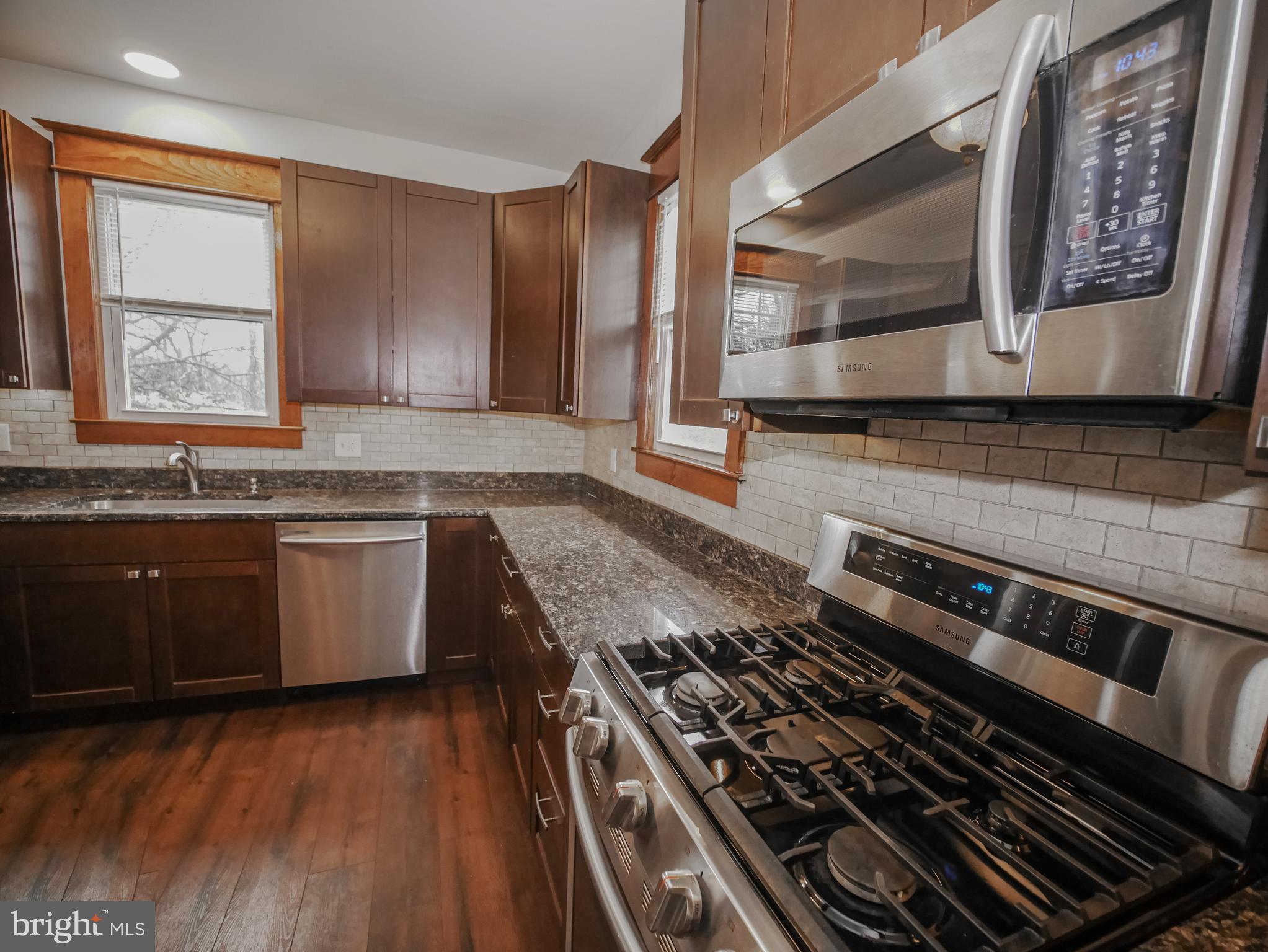 332 Crown Point Road Thorofare, NJ 08086 - Photo 16 of 36 a kitchen with stainless steel appliances granite countertop a stove a sink and a microwave