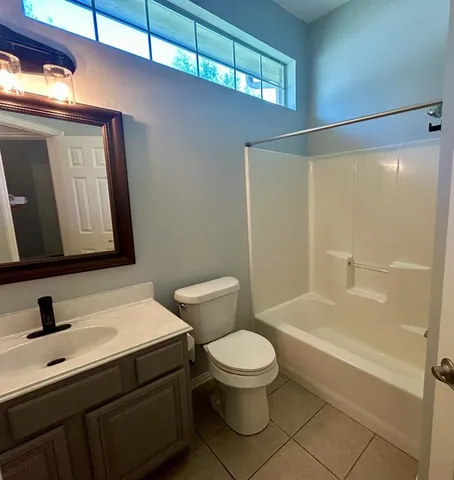 a bathroom with a sink mirror vanity and toilet