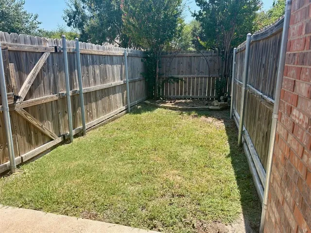 a view of backyard with wooden fence and deck