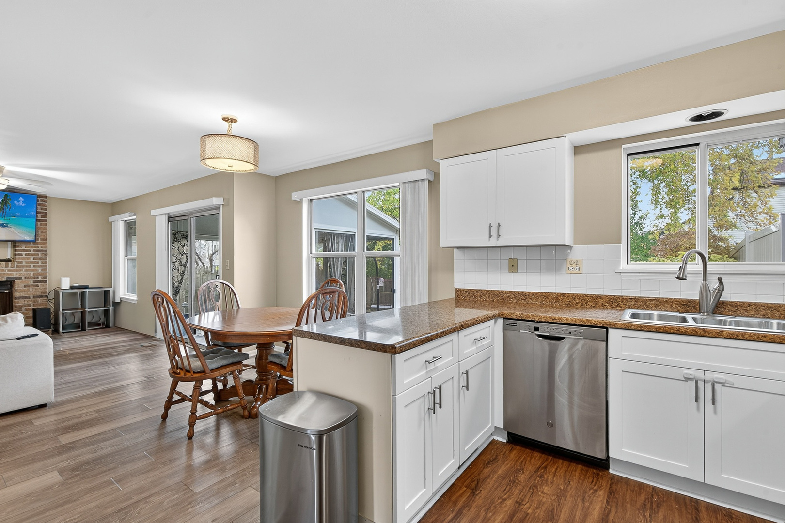 208 Bingham Circle Mundelein, IL 60060 - Photo 6 of 23 a kitchen with a sink cabinets and dining table chair