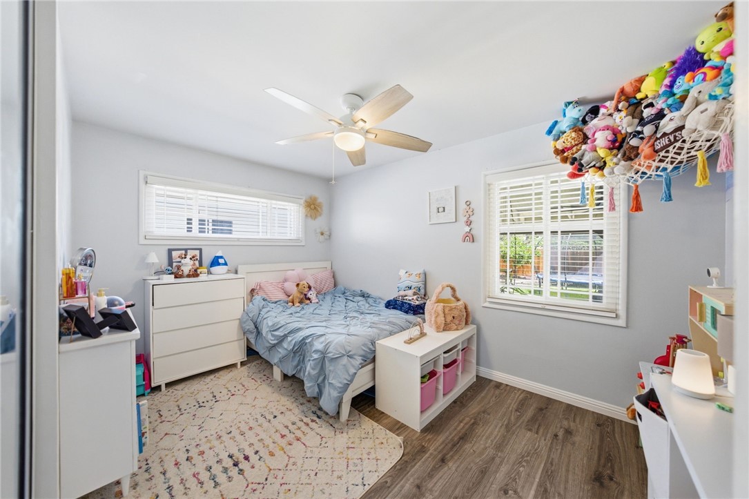 4869 Serrano Place Riverside, CA 92504 - Photo 27 of 40 Light-filled secondary bedroom with large windows, ceiling fan, and flexible space for family, guests, or a home office.