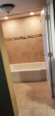 a bathroom with a shower and a bath tub
