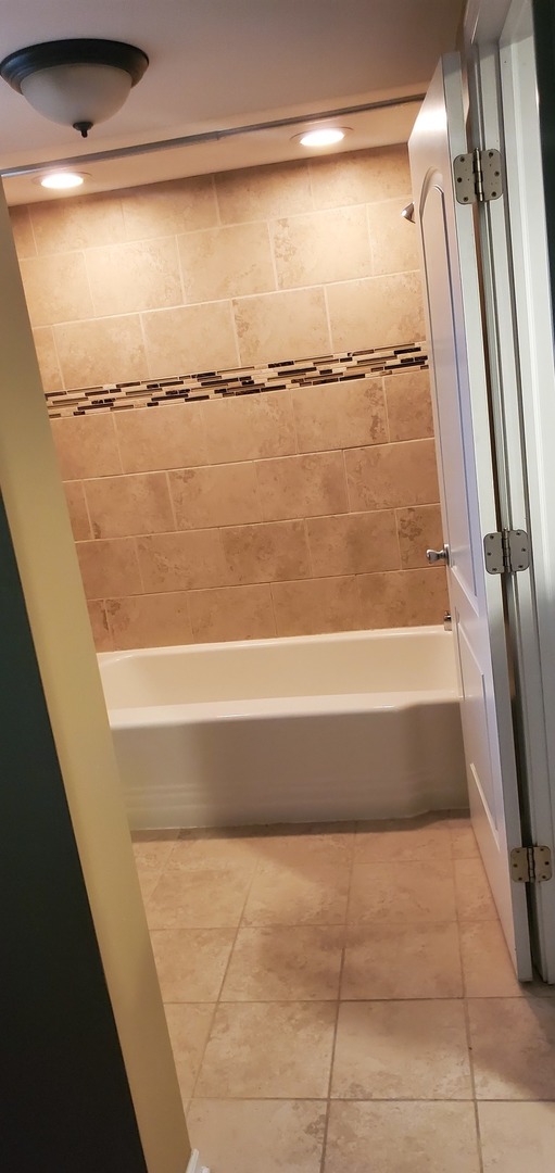 2212 Downey Road Homewood, IL 60430 - Photo 13 of 18 a bathroom with a shower and a bath tub